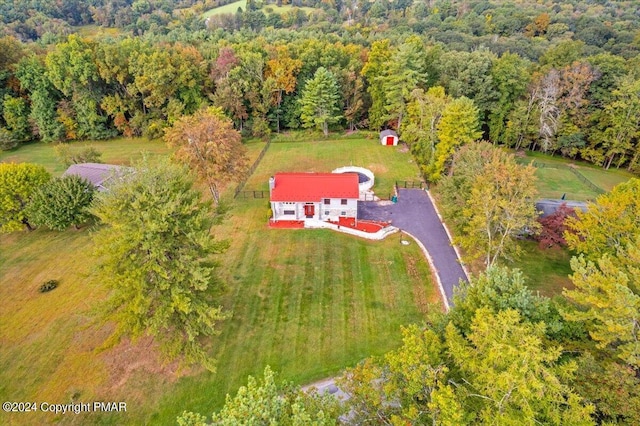 birds eye view of property with a forest view