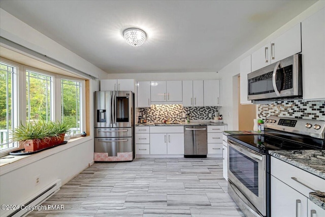 kitchen with a baseboard heating unit, appliances with stainless steel finishes, and white cabinetry