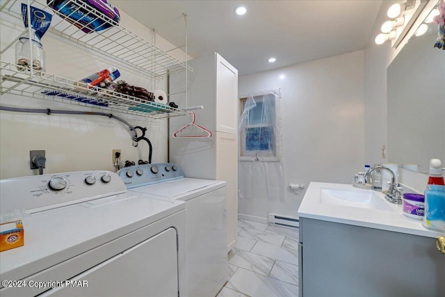 laundry area featuring marble finish floor, a baseboard heating unit, a sink, washer and dryer, and laundry area