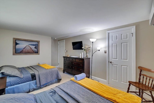 bedroom featuring light carpet and baseboards