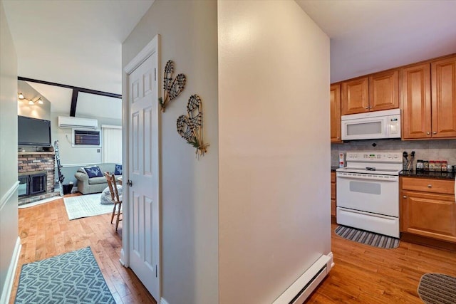 kitchen featuring light wood-style flooring, white appliances, an AC wall unit, a brick fireplace, and backsplash