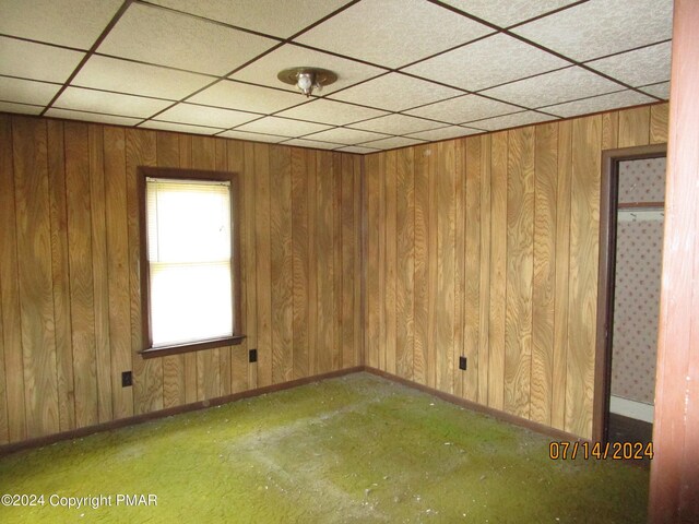 spare room with wooden walls