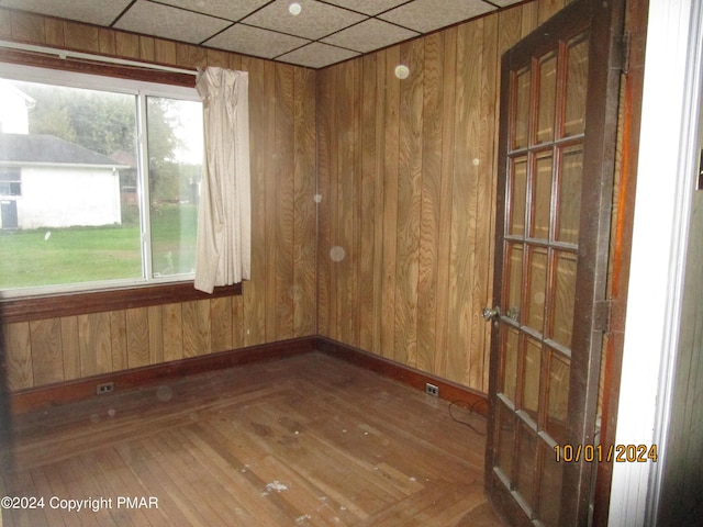 146 Buttonwood St, Jessup, PA 18434 - empty room featuring a paneled ceiling, wood finished floors, baseboards, and wood walls