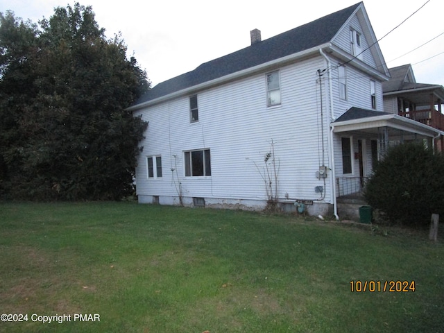 146 Buttonwood St, Jessup, PA 18434 - view of side of home featuring a lawn and a chimney