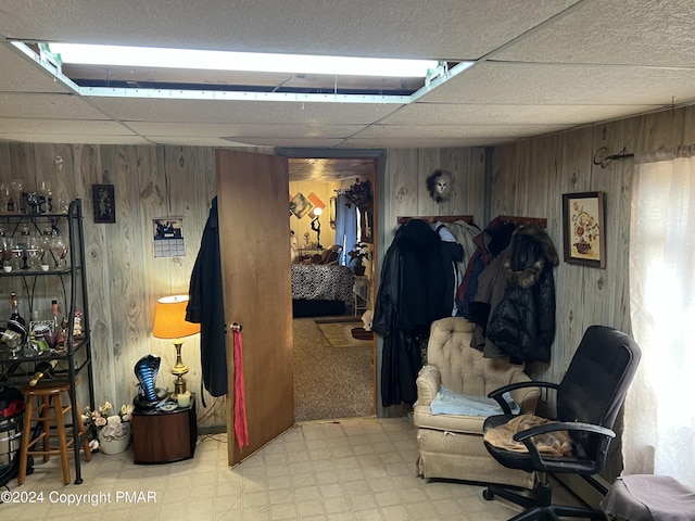 interior space with wooden walls and tile patterned floors