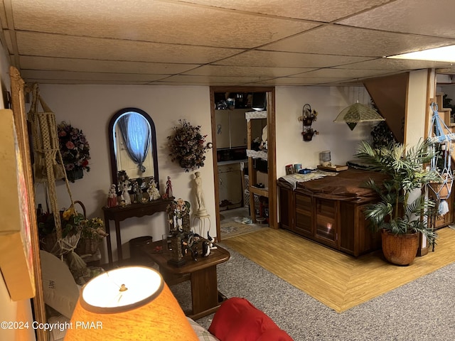 interior space featuring a paneled ceiling and wood finished floors