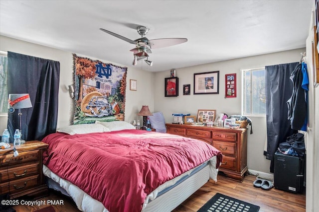 bedroom with wood finished floors and baseboards