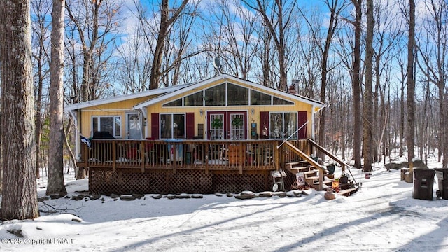 rustic home with french doors and a wooden deck