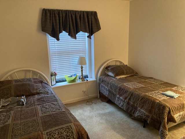 carpeted bedroom featuring baseboards