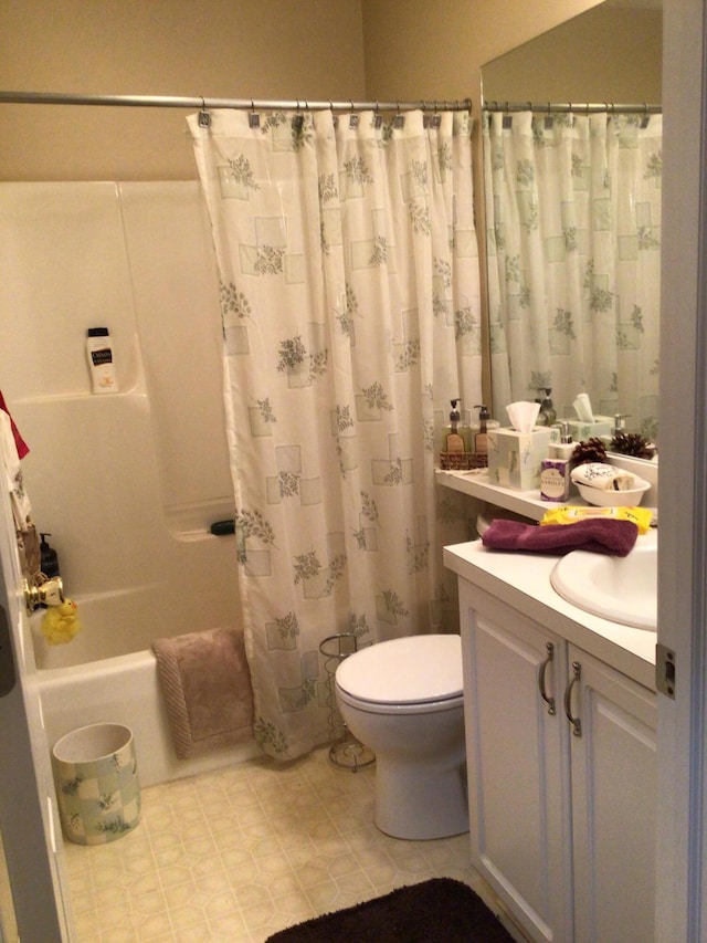 bathroom featuring shower / bath combo with shower curtain, toilet, and vanity