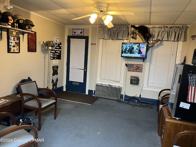 sitting room featuring ceiling fan, a paneled ceiling, and radiator