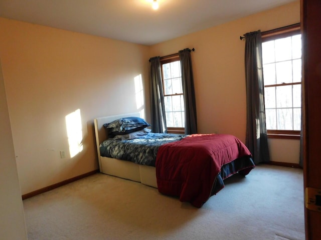 bedroom with carpet flooring and baseboards