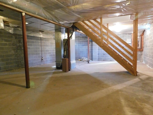 unfinished basement with concrete block wall