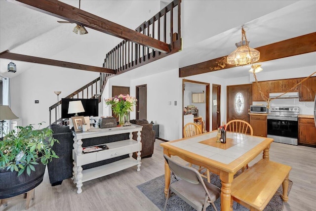 41 Pinoak Dr, Jim Thorpe, PA 18229 - dining room with stairway, beamed ceiling, light wood-style floors, a high ceiling, and a chandelier
