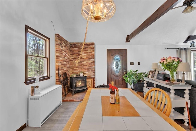 41 Pinoak Dr, Jim Thorpe, PA 18229 - dining space featuring radiator heating unit, a wood stove, a chandelier, wood finished floors, and a ceiling fan