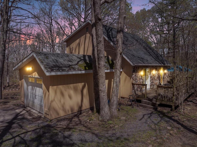 41 Pinoak Dr, Jim Thorpe, PA 18229 - property exterior at dusk featuring a detached garage, a wooden deck, and roof with shingles