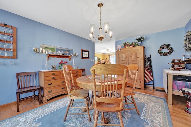 dining room featuring a ceiling fan, baseboards, and wood finished floors