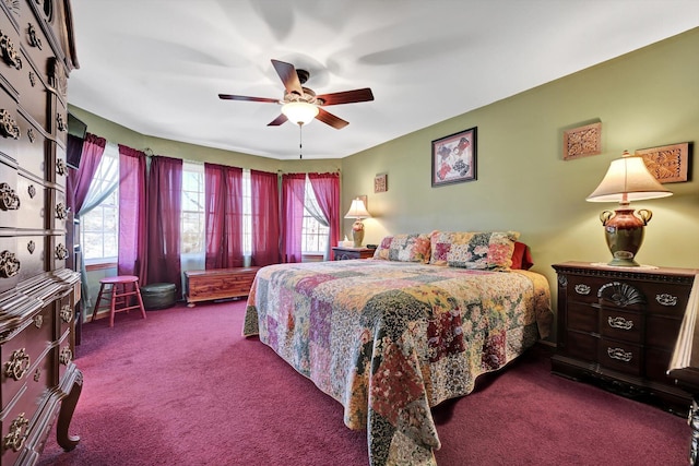 carpeted bedroom featuring multiple windows and ceiling fan