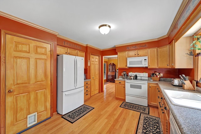 kitchen featuring white appliances, light wood finished floors, a sink, light countertops, and crown molding