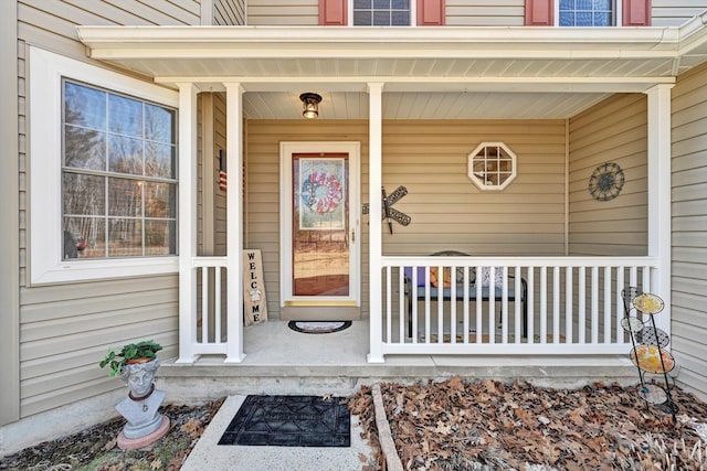 view of exterior entry with a porch