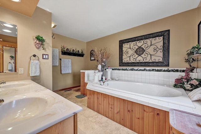 full bath featuring a garden tub, double vanity, lofted ceiling, and a sink