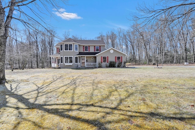 view of front of house with a front yard and covered porch