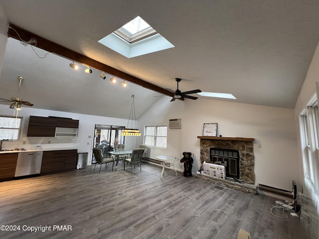 living room featuring vaulted ceiling with beams, a textured ceiling, a ceiling fan, and wood finished floors