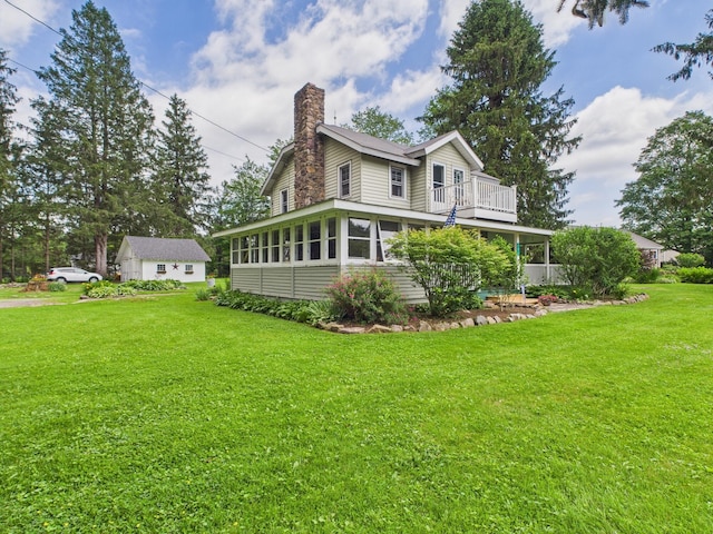 203 Old Rte 940, Pocono Pines, PA 18350 - back of house with a chimney, a balcony, and a yard