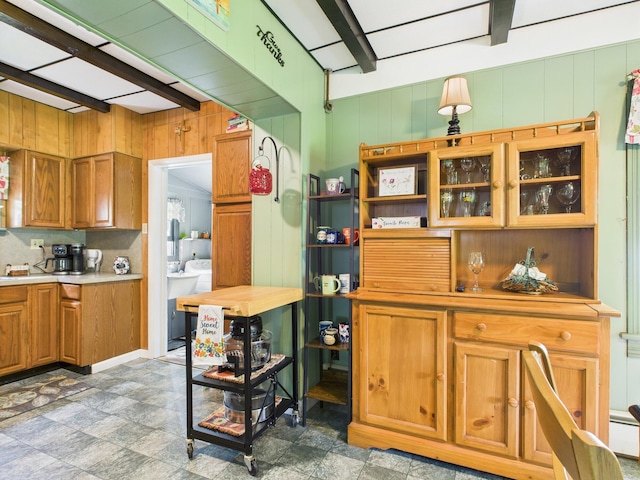 203 Old Rte 940, Pocono Pines, PA 18350 - kitchen featuring beamed ceiling, brown cabinetry, light countertops, and wooden walls