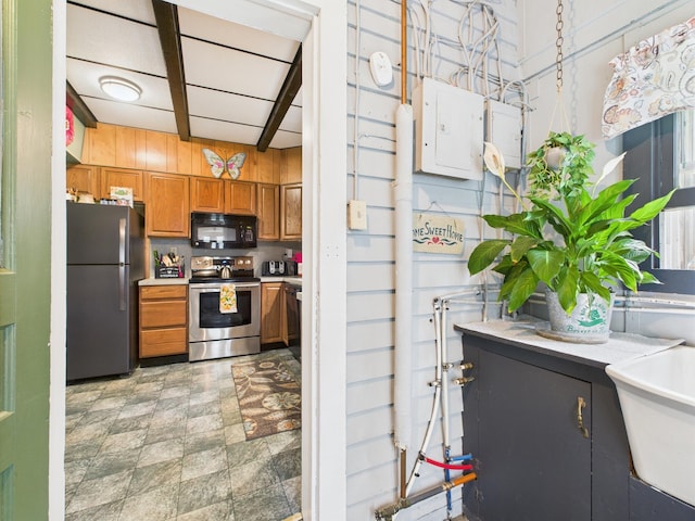 203 Old Rte 940, Pocono Pines, PA 18350 - kitchen with stainless steel range with electric cooktop, freestanding refrigerator, black microwave, brown cabinetry, and electric panel