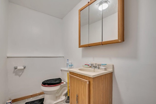 bathroom featuring toilet and vanity