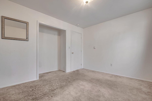 unfurnished bedroom featuring baseboards and carpet