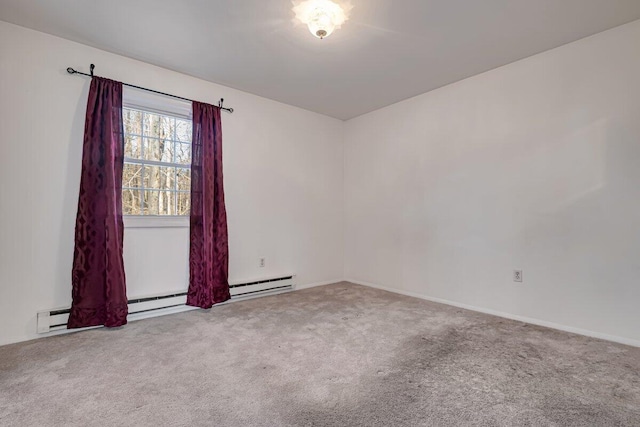 carpeted spare room featuring baseboard heating