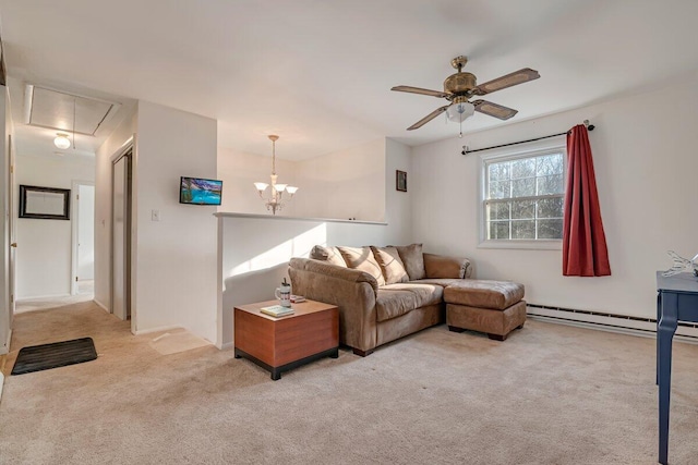 carpeted living area with attic access, ceiling fan with notable chandelier, and a baseboard radiator