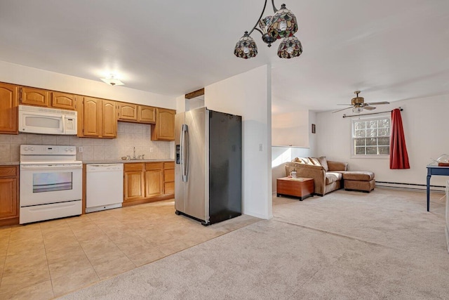 kitchen featuring a baseboard heating unit, white appliances, light colored carpet, and a sink