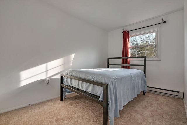 carpeted bedroom featuring a baseboard radiator and baseboards