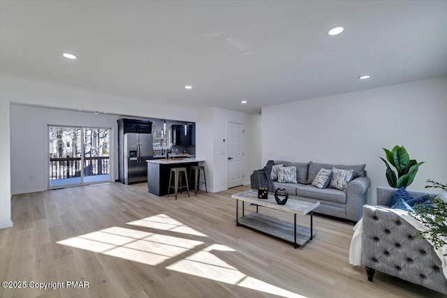 living room featuring light wood finished floors and recessed lighting