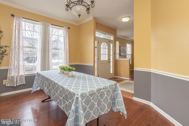 dining room with ornamental molding and dark hardwood / wood-style floors