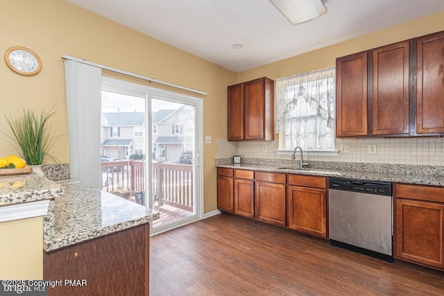 kitchen with sink, dark wood-type flooring, dishwasher, tasteful backsplash, and light stone countertops