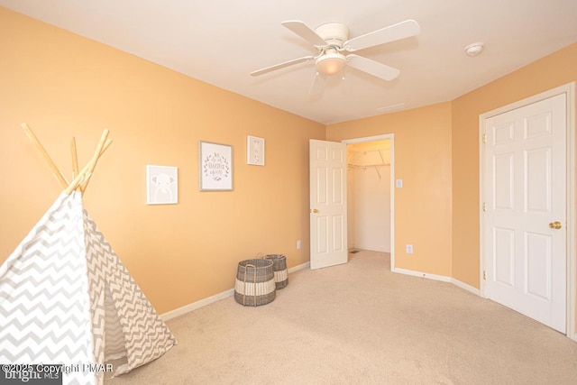 game room featuring light carpet and ceiling fan