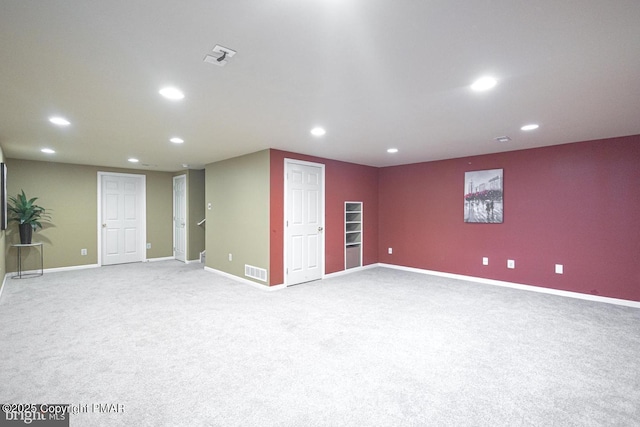 unfurnished room featuring light colored carpet