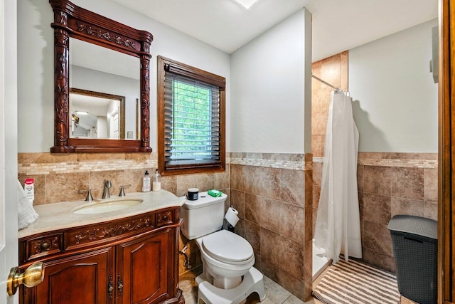 108 Bayberry Ct, Stroudsburg, PA 18360 - bathroom featuring tile walls, a stall shower, vanity, a wainscoted wall, and tile patterned flooring