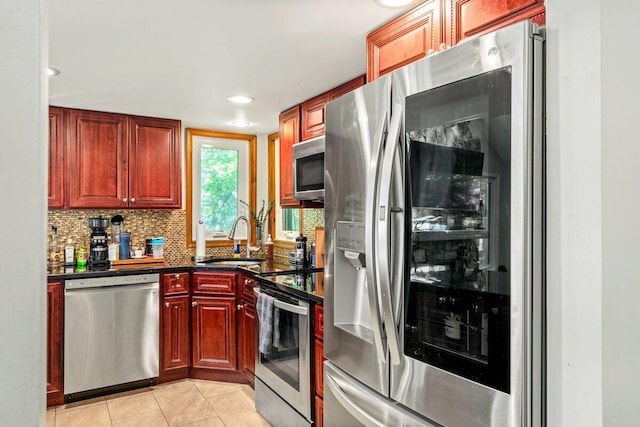 108 Bayberry Ct, Stroudsburg, PA 18360 - kitchen with stainless steel appliances, dark countertops, decorative backsplash, light tile patterned floors, and recessed lighting