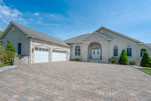 901 Meyer Rd, Nazareth, PA 18064 - ranch-style house featuring stucco siding, brick siding, an attached garage, and decorative driveway