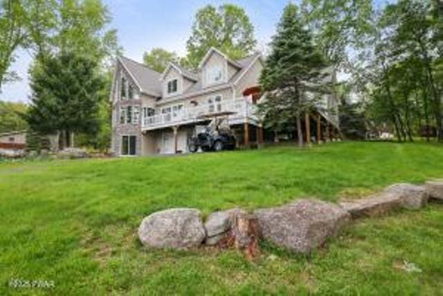 7 Shore Line Dr, Lakeville, PA 18438 - rear view of property featuring a lawn and a deck