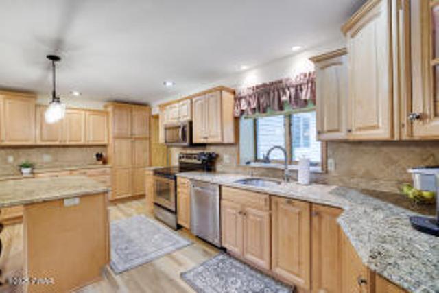 7 Shore Line Dr, Lakeville, PA 18438 - kitchen with appliances with stainless steel finishes, a sink, light brown cabinetry, backsplash, and light stone counters