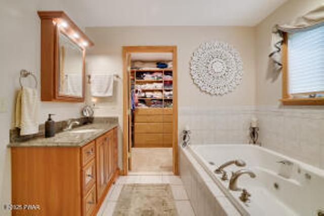 7 Shore Line Dr, Lakeville, PA 18438 - full bath with vanity, a bath, and tile patterned flooring