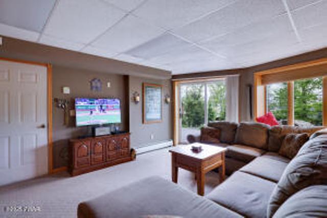 7 Shore Line Dr, Lakeville, PA 18438 - carpeted living area with a baseboard heating unit and a drop ceiling