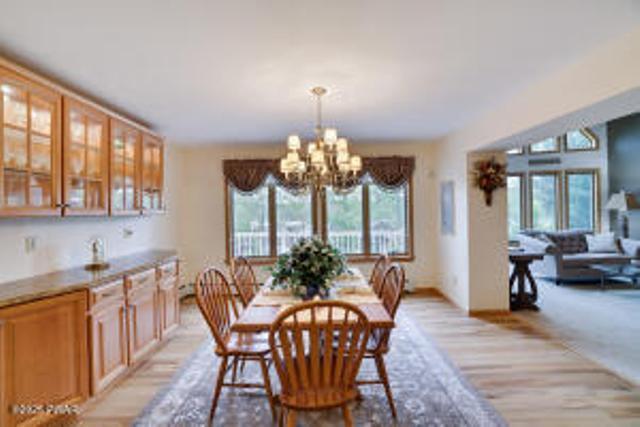 7 Shore Line Dr, Lakeville, PA 18438 - dining room featuring healthy amount of natural light, a chandelier, and light wood-type flooring