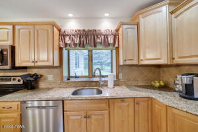 7 Shore Line Dr, Lakeville, PA 18438 - kitchen with stainless steel appliances, a sink, light brown cabinetry, recessed lighting, and light stone counters